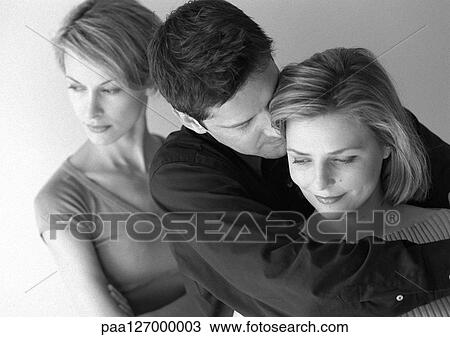 Woman standing behind couple hugging, b&w View Large Photo Image Stock Image - Woman standing behind couple hugging, b&w. Fotosearch