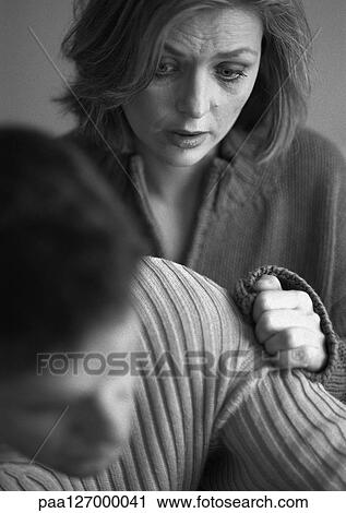 Stock Image - Woman touching man's arm, close-up, b&w. Fotosearch