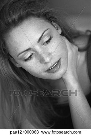 Stock Image - Woman touching neck, close-up, b&w. Fotosearch