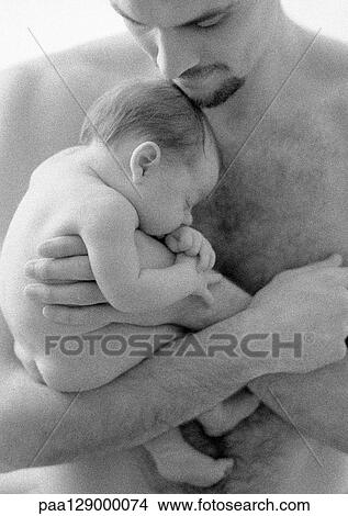 Father holding sleeping infant against bare chest, b&w View Large Photo Image Picture - Father holding sleeping infant against bare chest, b&w. Fotosearch