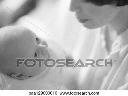 Stock Photograph - Infant looking at mother, high angle view, b&w. Fotosearch