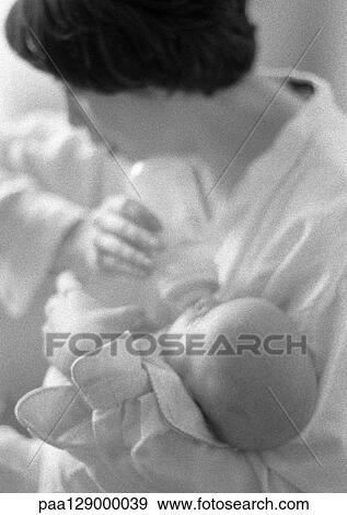 Mother bottle feeding infant, b&w View Large Photo Image Stock Photo - Mother bottle feeding infant, b&w. Fotosearch