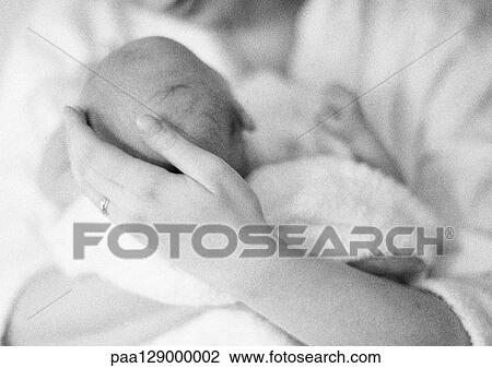 Stock Image - Mother holding infant, b&w. Fotosearch