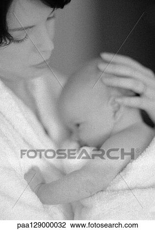 Stock Image - Mother holding infant, b&w. Fotosearch