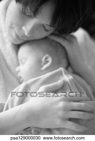 Stock Image - Mother holding sleeping infant, b&w. Fotosearch