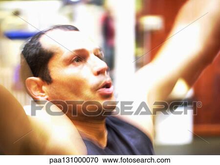 Man exercising and breathing deeply in gym View Large Photo Image Stock Image - Man exercising and breathing deeply in gym. Fotosearch