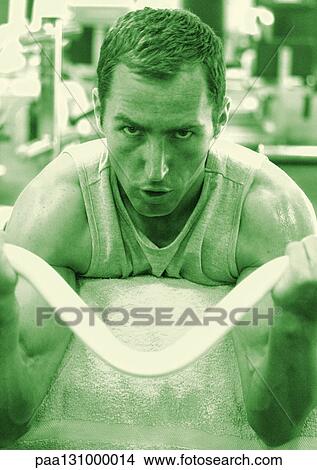 Man exercising in gym, head and shoulders View Large Photo Image Picture - Man exercising in gym, head and shoulders. Fotosearch