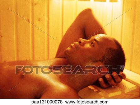 Man lying down in sauna View Large Photo Image Stock Photo - Man lying down in sauna. Fotosearch