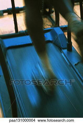Man running on treadmill, lower section, blurred motion View Large Photo Image Picture - Man running on treadmill, lower section, blurred motion. Fotosearch