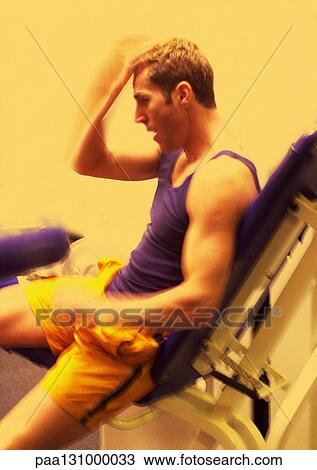 Man sitting on weight machine, side view View Large Photo Image Stock Image - Man sitting on weight machine, side view. Fotosearch