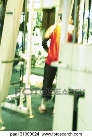 Man standing in gym, rear view View Large Photo Image Picture - Man standing in gym, rear view. Fotosearch