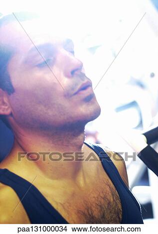 Man taking breath in gym, close-up View Large Photo Image Picture - Man taking breath in gym, close-up. Fotosearch