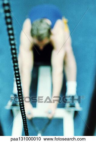 Man using exercise machine, high angle view View Large Photo Image Stock Image - Man using exercise machine, high angle view. Fotosearch
