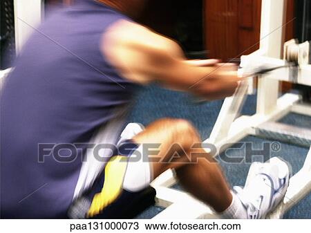 Man using rowing machine View Large Photo Image Stock Image - Man using rowing machine. Fotosearch