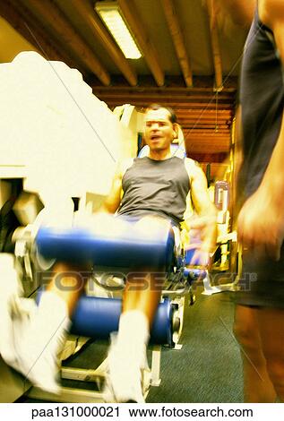 Man using weight machine in gym View Large Photo Image Stock Image - Man using weight machine in gym. Fotosearch