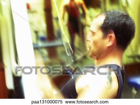 Man using weight machine in gym, blurred motion View Large Photo Image Stock Photography - Man using weight machine in gym, blurred motion. Fotosearch