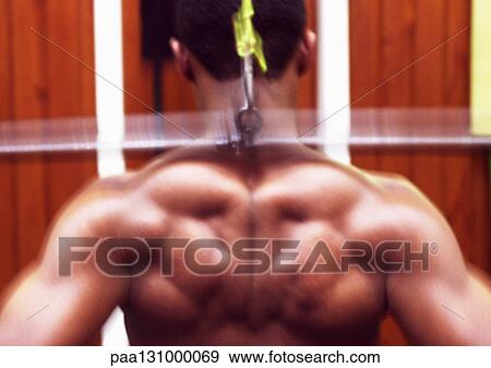 Man using weight machine, rear view View Large Photo Image Stock Photo - Man using weight machine, rear view. Fotosearch