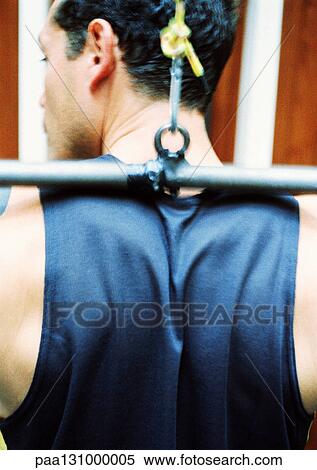 Man using weight machine, rear view, close-up View Large Photo Image Stock Photography - Man using weight machine, rear view, close-up. Fotosearch