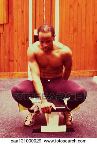 Man using weight machine View Large Photo Image Stock Photo - Man using weight machine. Fotosearch