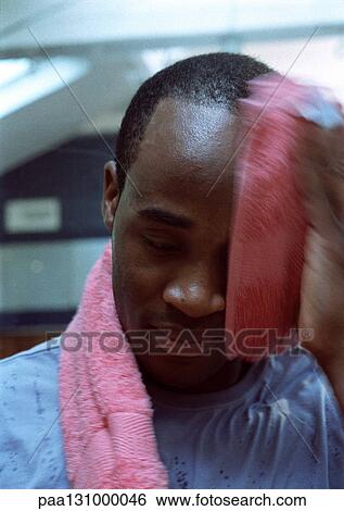 Man wiping off face with towel, close-up View Large Photo Image Stock Photograph - Man wiping off face with towel, close-up. Fotosearch
