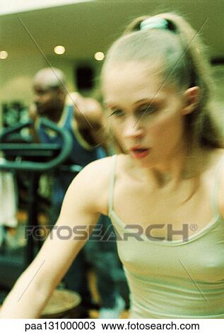 Stock Image - People working out in gym. Fotosearch