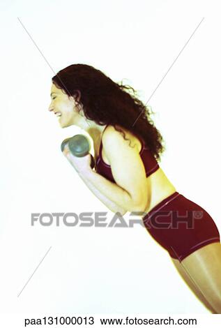 Woman lifting weights and laughing, side view View Large Photo Image Stock Image - Woman lifting weights and laughing, side view. Fotosearch