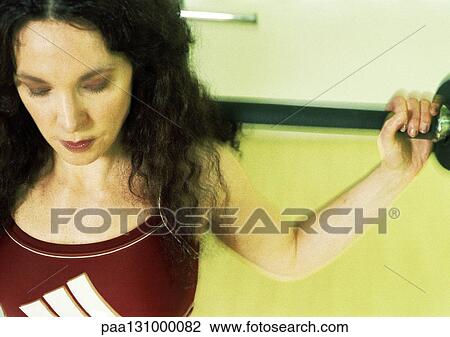 Woman lifting weights View Large Photo Image Stock Image - Woman lifting weights. Fotosearch