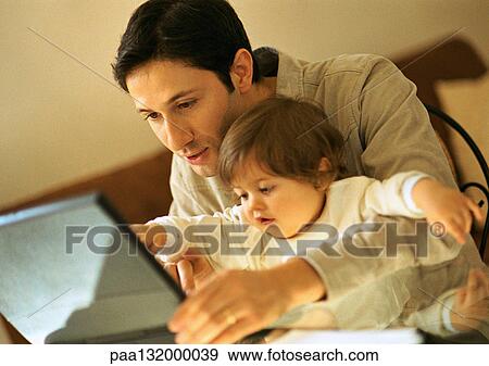 Father and baby using laptop. View Large Photo Image Stock Photo - Father and baby using laptop.. Fotosearch