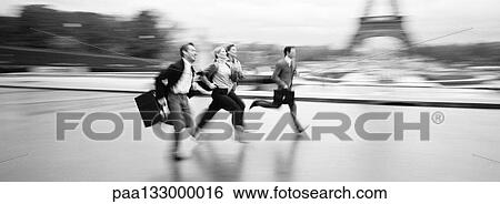 Business people running across esplanade in front of Eiffel Tower, b&w, panoramic view View Large Photo Image Stock Photograph - Business people running across esplanade in front of Eiffel Tower, b&w, panoramic view. Fotosearch
