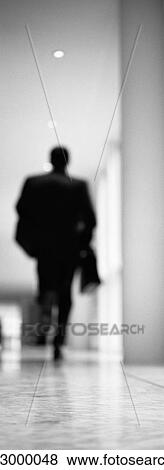 Businessman running in hallway, b&w, vertical, blurred View Large Photo Image Stock Photo - Businessman running in hallway, b&w, vertical, blurred. Fotosearch