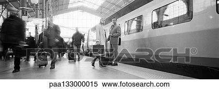Stock Photography - People on platform next to train, b&w, panoramic view. Fotosearch
