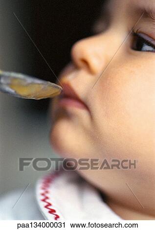 Baby being fed, close-up. View Large Photo Image Stock Image - Baby being fed, close-up.. Fotosearch
