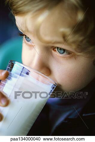 Stock Image - Child drinking from glass, close-up.. Fotosearch
