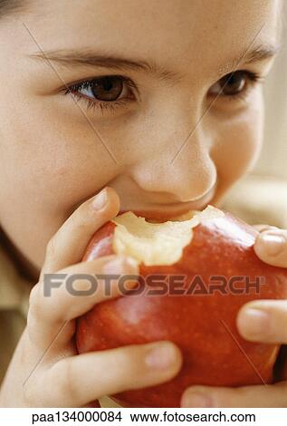 Child eating apple, close up. View Large Photo Image Picture - Child eating apple, close up.. Fotosearch