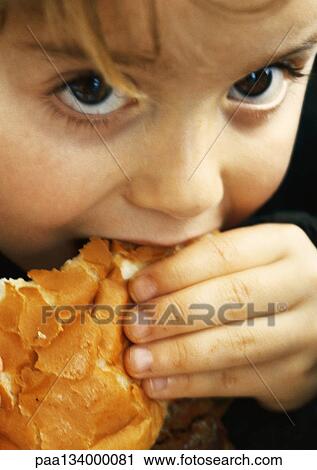 Child eating bread, close-up. View Large Photo Image Stock Image - Child eating bread, close-up.. Fotosearch