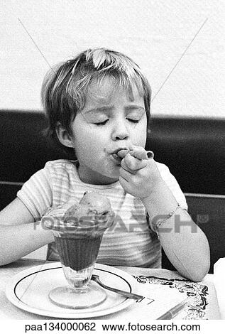 Child eating dessert, portrait, b&w. View Large Photo Image Stock Image - Child eating dessert, portrait, b&w.. Fotosearch