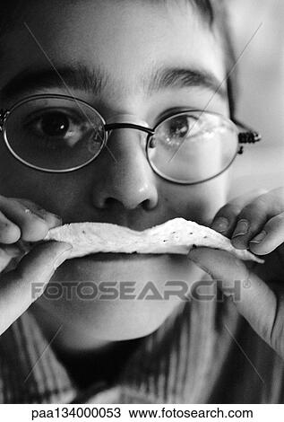 Child eating, looking into camera, close-up, b&w. View Large Photo Image Stock Image - Child eating, looking into camera, close-up, b&w.. Fotosearch