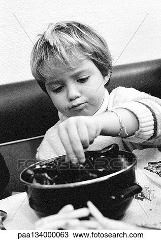 Child eating sea food, portrait, b&w. View Large Photo Image Stock Image - Child eating sea food, portrait, b&w.. Fotosearch