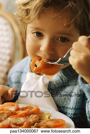 Child eating tomato slices, portrait. View Large Photo Image Stock Photo - Child eating tomato slices, portrait.. Fotosearch