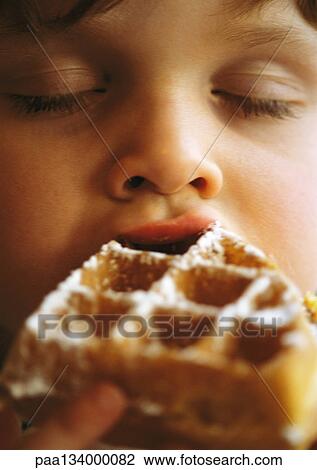 Child eating waffle, close-up. View Large Photo Image Stock Image - Child eating waffle, close-up.. Fotosearch