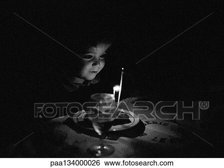 Child sitting at candle lit table, b&w. View Large Photo Image Stock Photograph - Child sitting at candle lit table, b&w.. Fotosearch