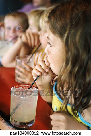 Children drinking through straws. View Large Photo Image Stock Image - Children drinking through straws.. Fotosearch