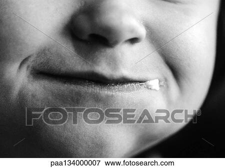 Stock Photo - Child's face, close-up on mouth, b&w.. Fotosearch