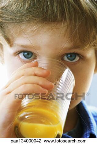 Little boy drinking juice, looking at camera, portrait, close-up. View Large Photo Image Stock Image - Little boy drinking juice, looking at camera, portrait, close-up.. Fotosearch