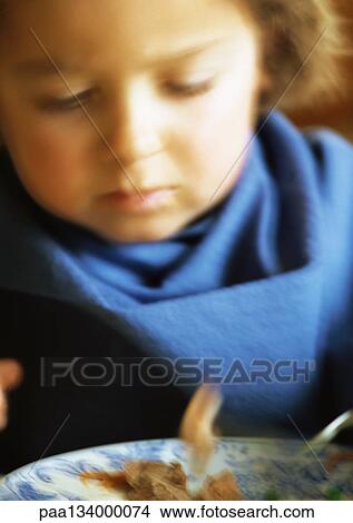 Picture - Little girl eating, blurred, portrait.. Fotosearch