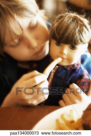 Little girl feeding doll, portrait. View Large Photo Image Stock Image - Little girl feeding doll, portrait.. Fotosearch