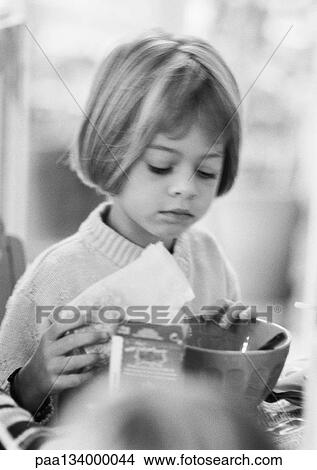 Little girl preparing breakfast, portrait, b&w. View Large Photo Image Picture - Little girl preparing breakfast, portrait, b&w.. Fotosearch