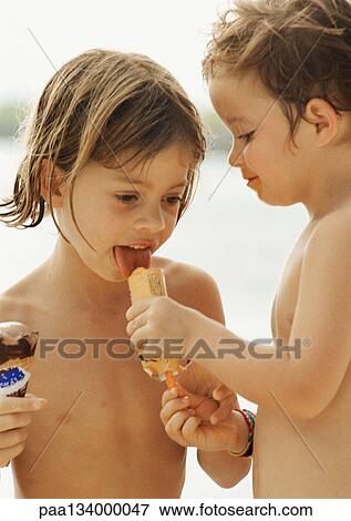Stock Photo - Two children sharing ice cream, portrait.. Fotosearch