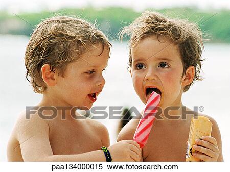 Two young children sharing popsicles, head and shoulders, portrait. View Large Photo Image Stock Photography - Two young children sharing popsicles, head and shoulders, portrait.. Fotosearch