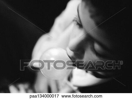 Stock Photo - Young child blowing bubble, b&w.. Fotosearch